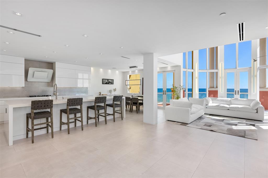 2140 North Ocean Boulevard, Unit V Fort Lauderdale, FL 33305 - Photo 29 of 63 a living room with furniture and a large window