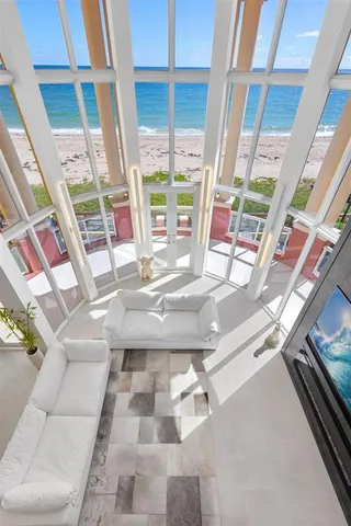 a view of staircase with lots of frames on wall and wooden floor
