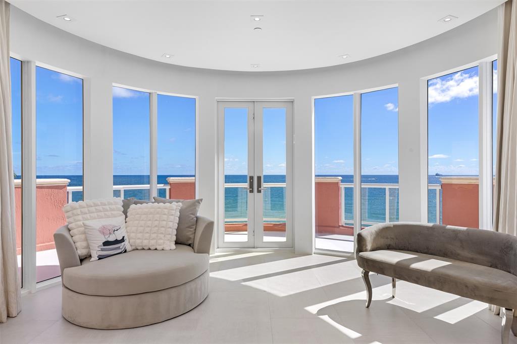 2140 North Ocean Boulevard, Unit V Fort Lauderdale, FL 33305 - Photo 42 of 63 a living room with furniture and a lamp