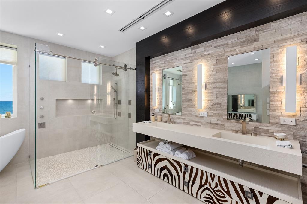 2140 North Ocean Boulevard, Unit V Fort Lauderdale, FL 33305 - Photo 45 of 63 a bathroom with a sink a mirror and a shower