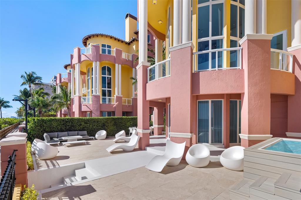 2140 North Ocean Boulevard, Unit V Fort Lauderdale, FL 33305 - Photo 54 of 63 a view of a patio with couches table and chairs and potted plants