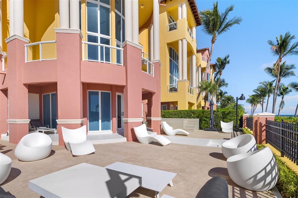 2140 North Ocean Boulevard, Unit V Fort Lauderdale, FL 33305 - Photo 61 of 63 a view of a patio with couches table and chairs and potted plants