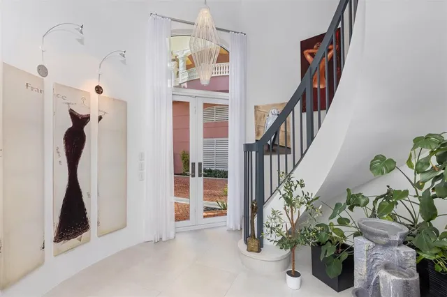 a living room with furniture and a floor to ceiling window