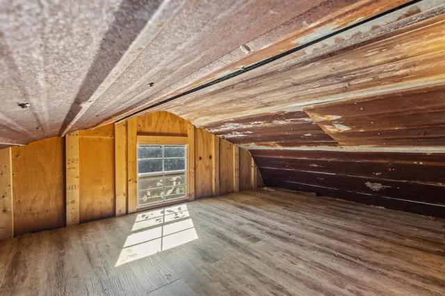 a room with wooden floor and furniture