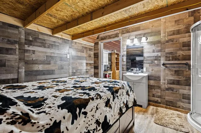 a bed sitting in a bedroom next to a bathroom