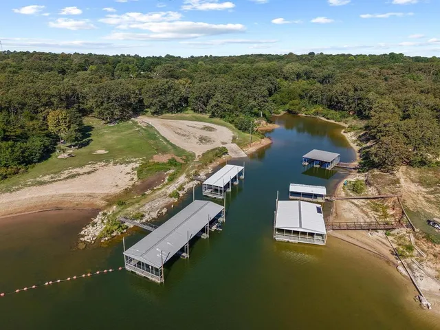 an aerial view of residential houses with outdoor space and ocean view