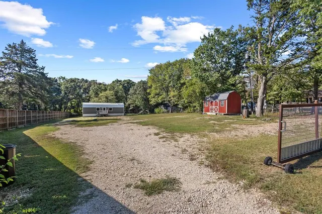 a view of a backyard with trampoline