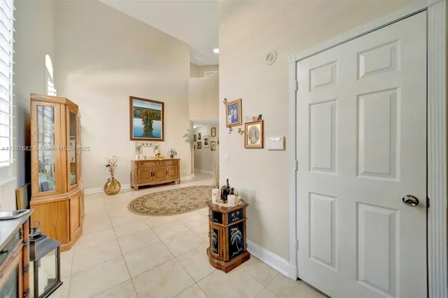 a view of a dining room with furniture a chandelier and wooden floor