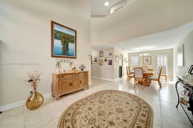 a kitchen with a refrigerator and a stove top oven