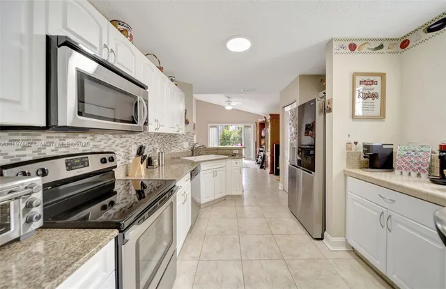 a view of hallway with furniture and windows