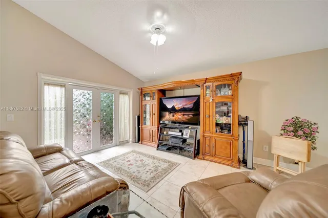 a bedroom with a bed and a ceiling fan