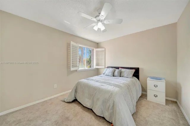 a bedroom with a bed couches and window