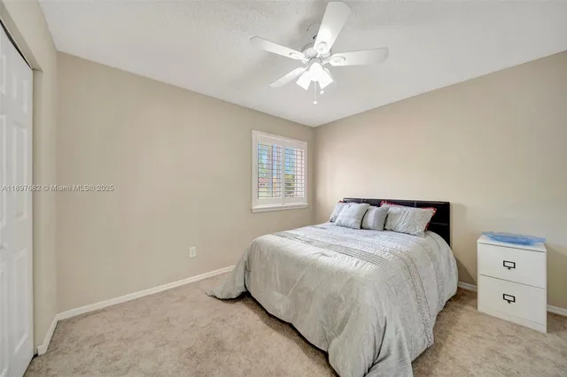 a bathroom with a granite countertop sink mirror and a bathtub