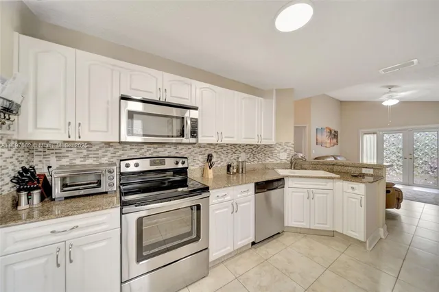 a living room with furniture a large window and a flat screen tv