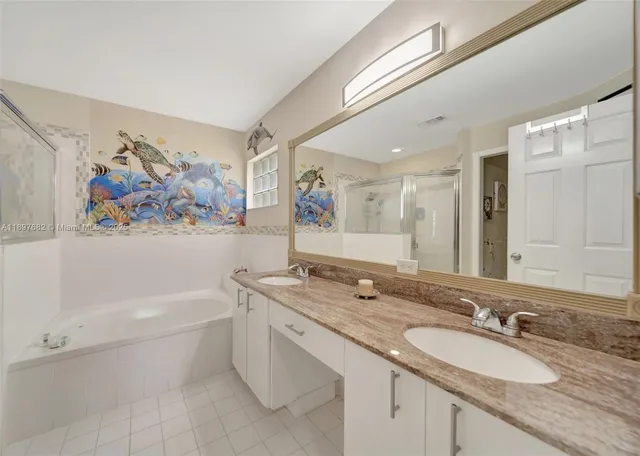 an aerial view of residential houses with outdoor space and trees