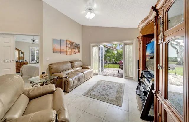 a living room with furniture and a mirror