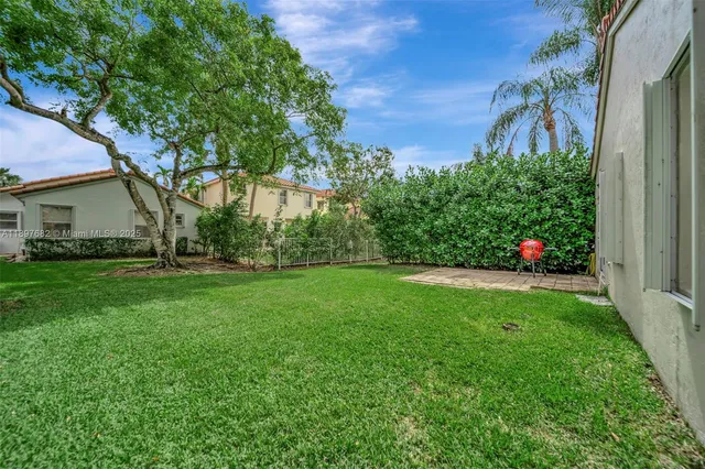 a living room with furniture a flat screen tv and gym equipment