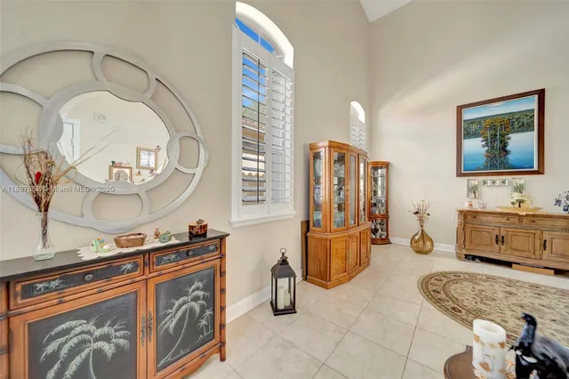 a view of a dining room with furniture and a potted plant