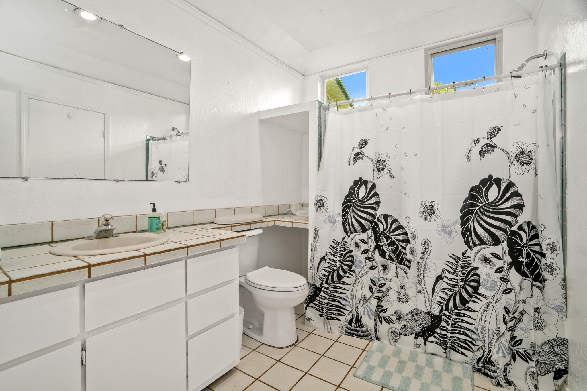 5366 Kumole Street Kapaa, HI 96746 - Photo 21 of 30 a bathroom with a granite countertop sink a toilet and a shower