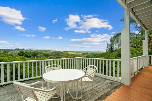 a view of a chair and table on the wooden deck