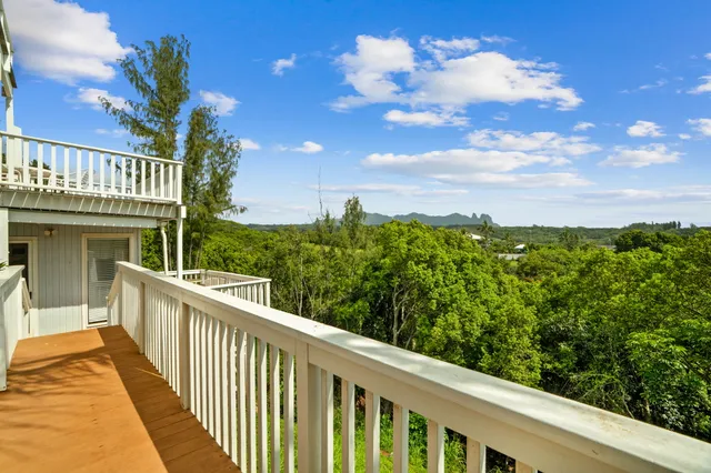 a view of a balcony with wooden fence