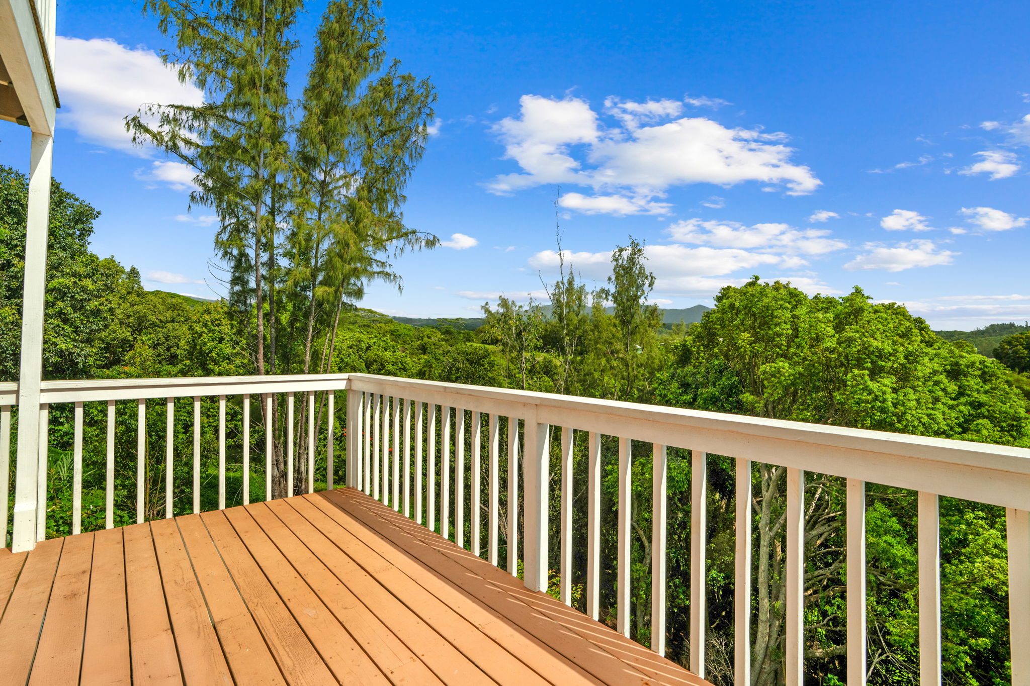 5366 Kumole Street Kapaa, HI 96746 - Photo 26 of 30 a balcony with wooden floor in front of it