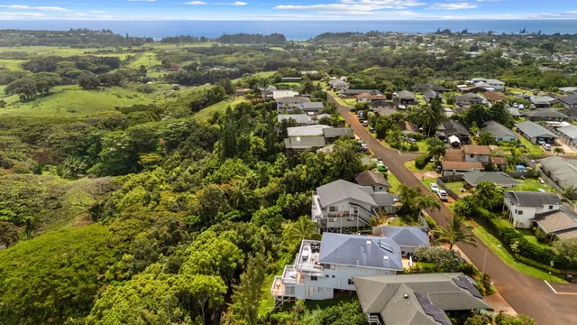 an aerial view of a houses with a yard