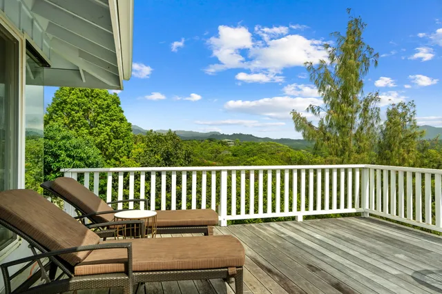 a view of a chair and table on the wooden deck