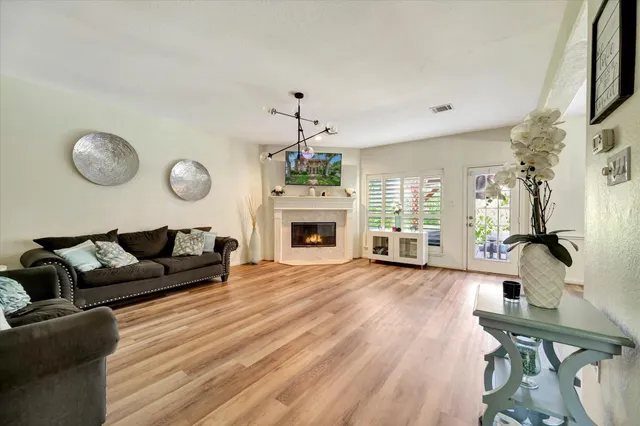 a spacious bedroom with a bed and a chandelier