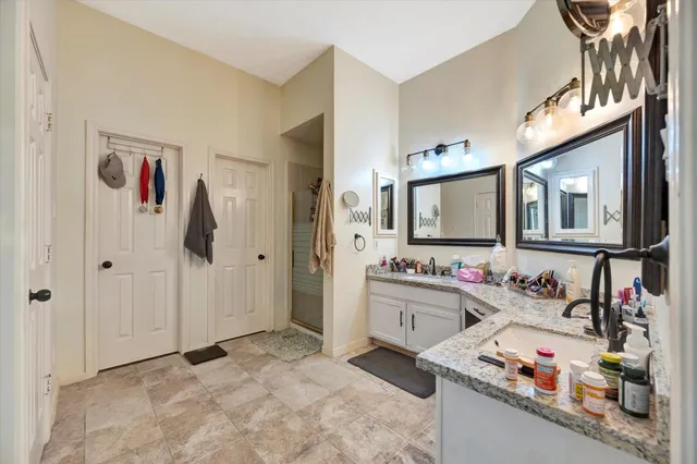 a bathroom with a sink vanity and mirror