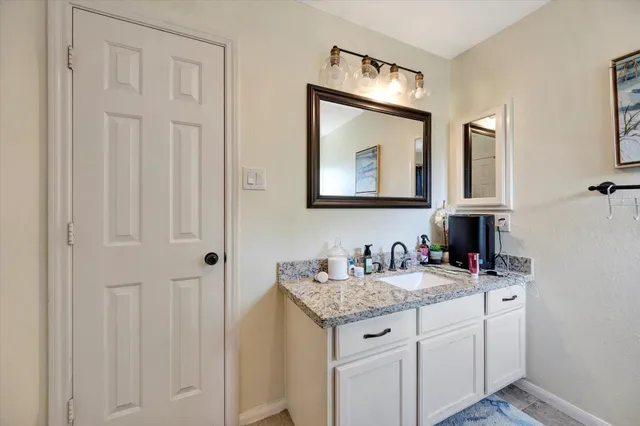 a bathroom with 2 sink and a mirror