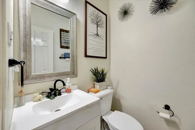 a bathroom with a toilet sink and mirror