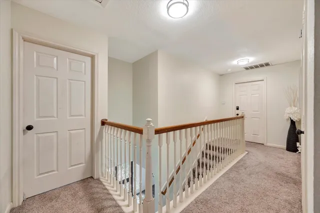 a view of a hallway with a window and stairs