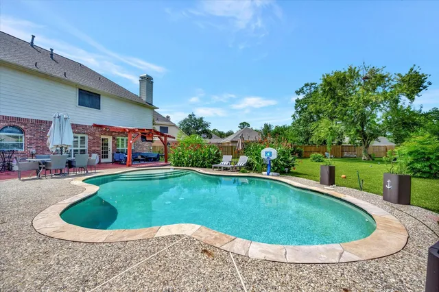 a view of a swimming pool and a yard