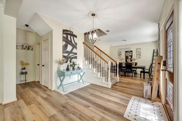 a view of entryway and hall with wooden floor