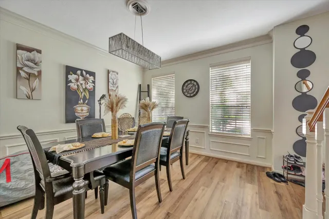 a view of a dining room with furniture large window and wooden floor