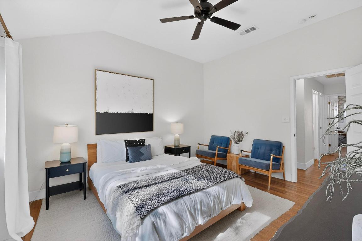 2511 Ashley Way Austin, TX 78744 - Photo 12 of 23 Primary bedroom with wood floors, a ceiling fan