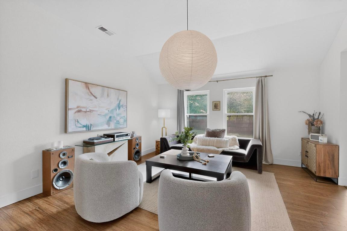 2511 Ashley Way Austin, TX 78744 - Photo 3 of 23 Living room with wood floors and large windows