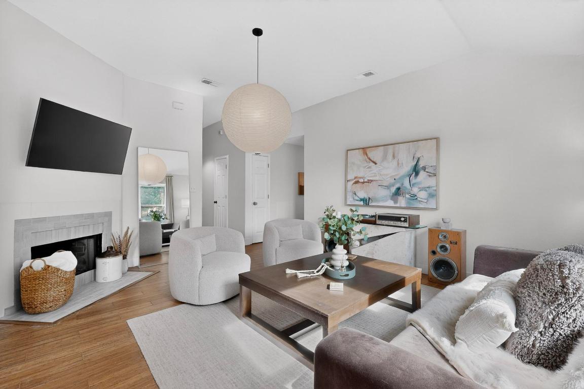 2511 Ashley Way Austin, TX 78744 - Photo 5 of 23 Living room with wood floors and a fireplace