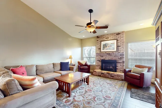 a living room with furniture a fireplace and a chandelier