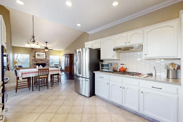 a kitchen with stainless steel appliances granite countertop a stove and a sink