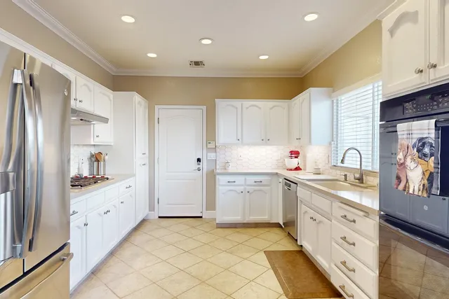 a kitchen with a refrigerator and a sink
