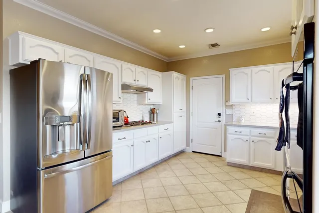 a kitchen with stainless steel appliances granite countertop a sink and cabinets