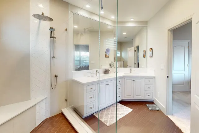 a bathroom with a double vanity sink mirror and toilet