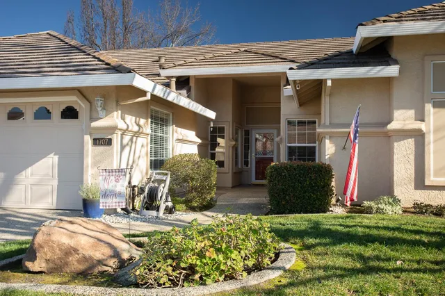 a living room with furniture and flowers