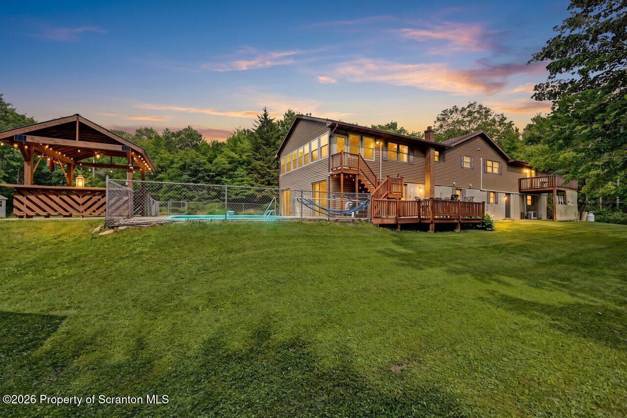a front view of a house with a garden and deck