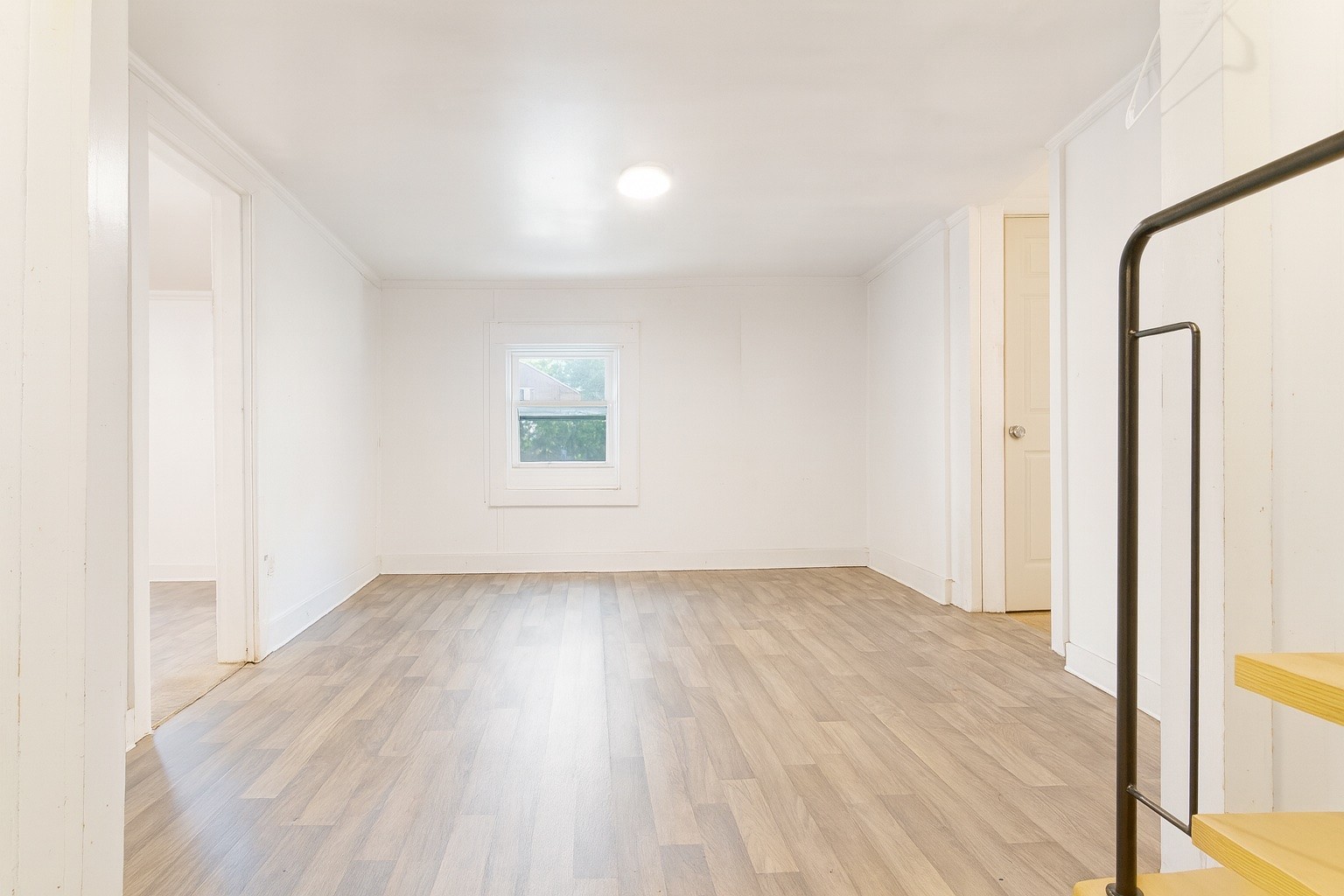 309 Harris Street Madison, TN 37115 - Photo 4 of 52 a view of an empty room with wooden floor and a window