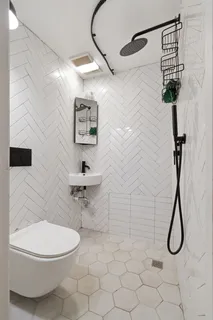 a bathroom with a toilet and a shower