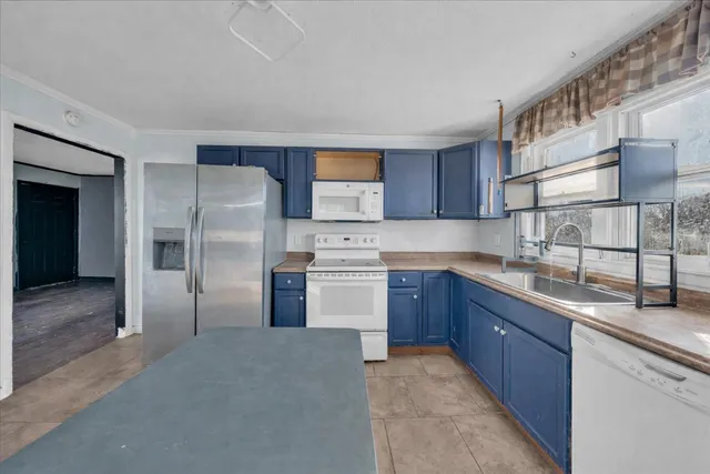 a kitchen with stainless steel appliances granite countertop a refrigerator sink and cabinets