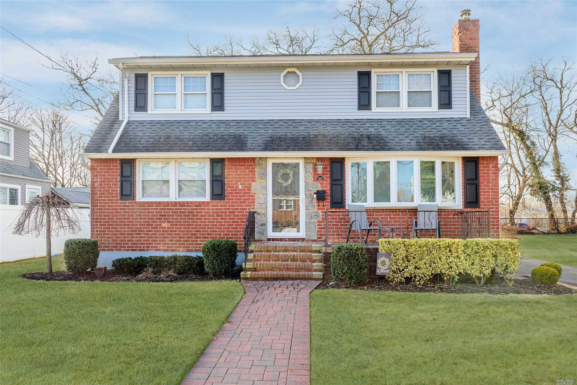 1684 Foxglove Road Merrick, NY 11566 - Photo 1 of 1 a front view of a house with a garden
